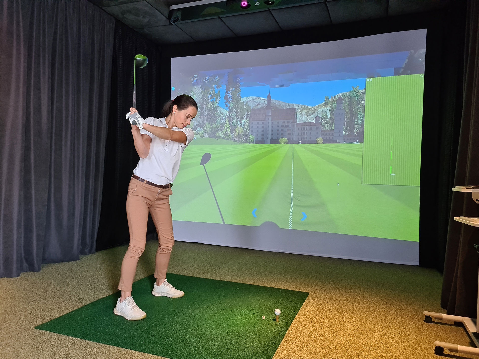 indoor golf simulator girl swinging